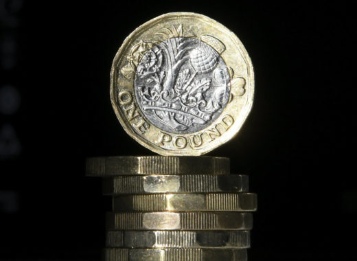This file photo taken on October 05, 2017 shows British one pound sterling coins arranged for a photograph in central London. Britain's old one-pound coin is being phased out completely on October 15, 2017, but businesses complain they have been given too little time to switch to the new one and many are planning to defy the deadline. Daniel SORABJI / AFP